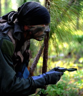 A soldier using navigation skills in his SERE training