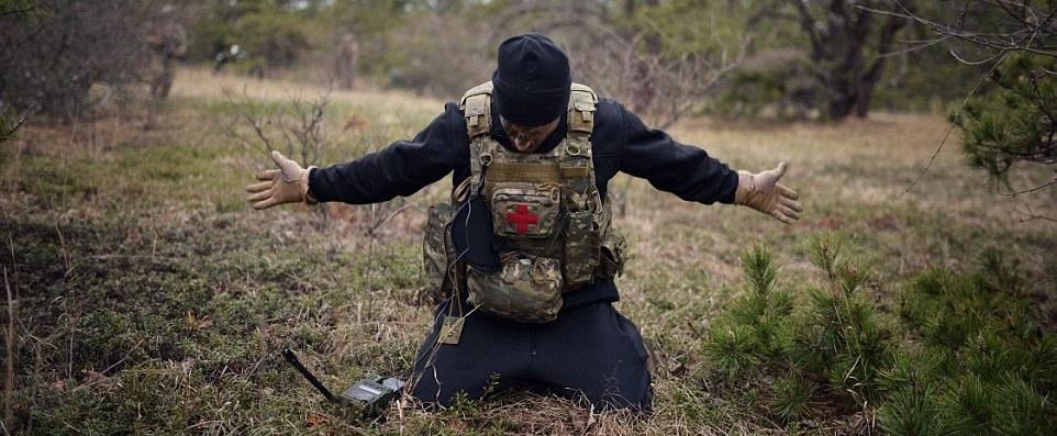 A trainee is caught by SERE instructors on a special forces course