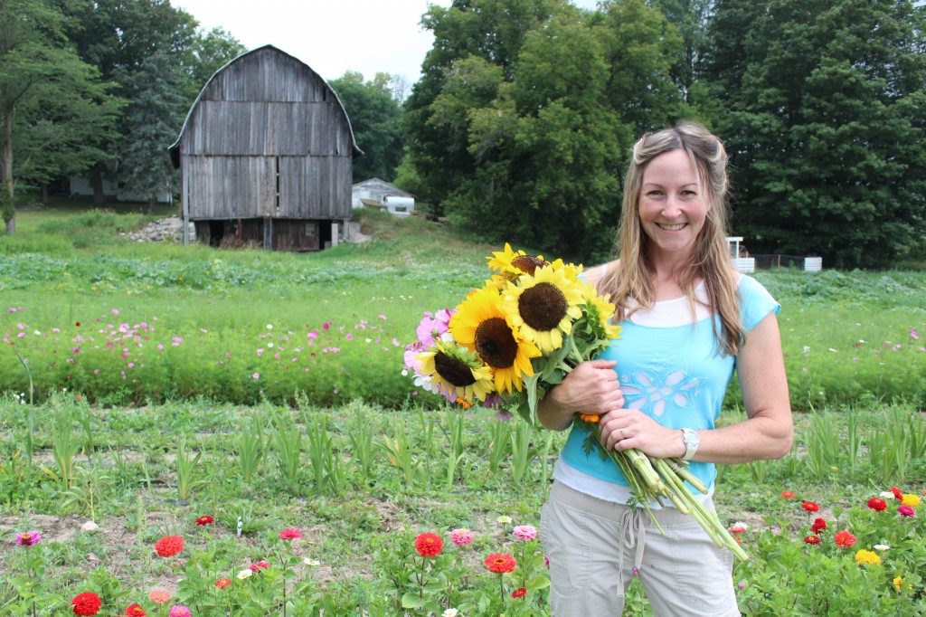 a woman with a flower Infront of her house