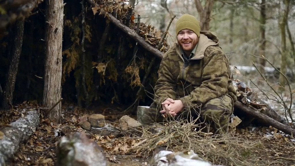 man in the woods smiling