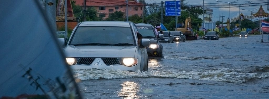 cars running in a flooded area