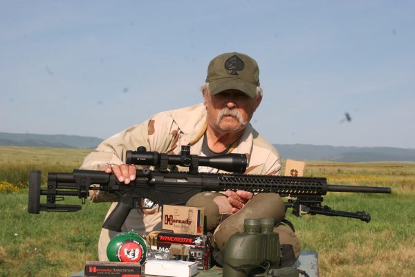 old man holding a Creedmoor mounting scope rifle