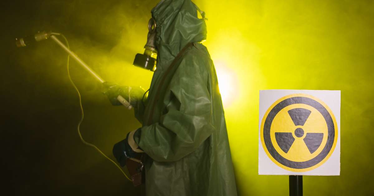 A man with full protective clothing and gas mask testing the radiation levels around the area. 