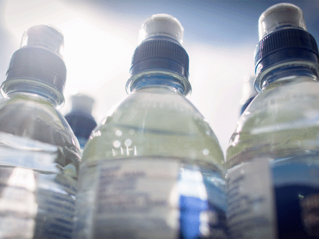 Three full water bottles exposed to the sun.