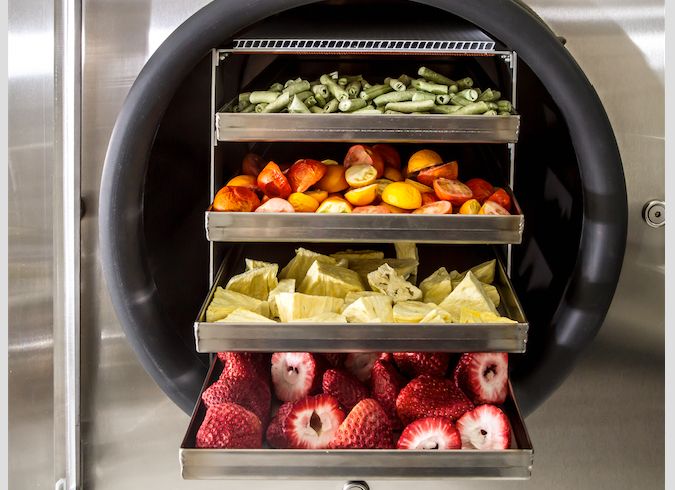 A tray of freeze-dried green beans, tomatoes, pineapples, and strawberries. 