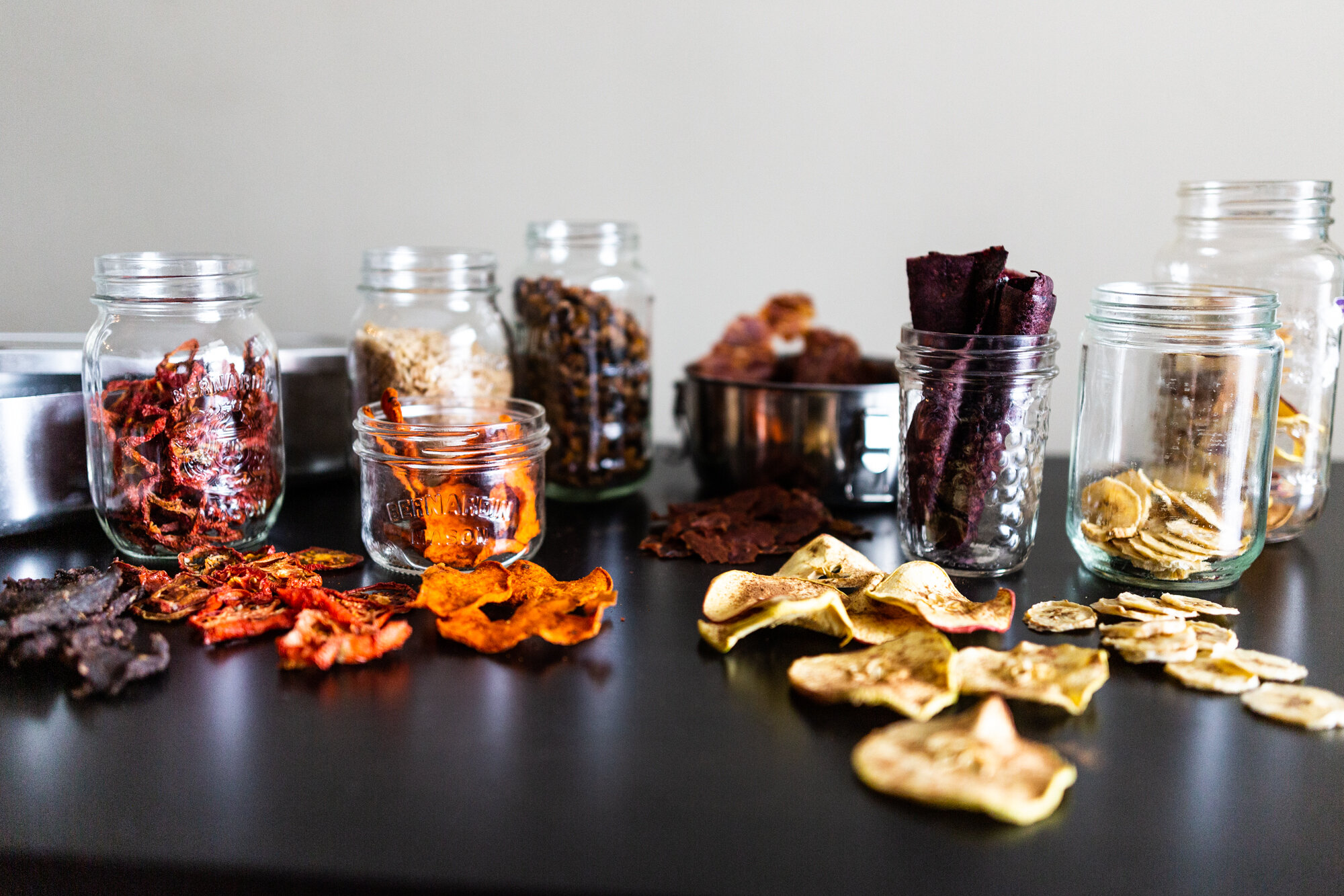 Jars full of dehydrated fruits and vegetables for long-term storage.