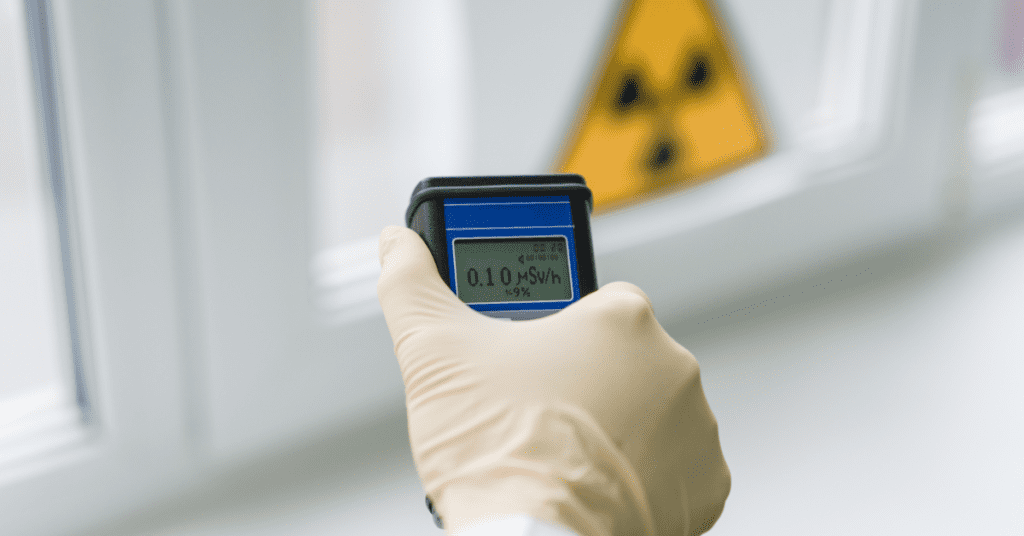 a person holding a radiation dosimeter