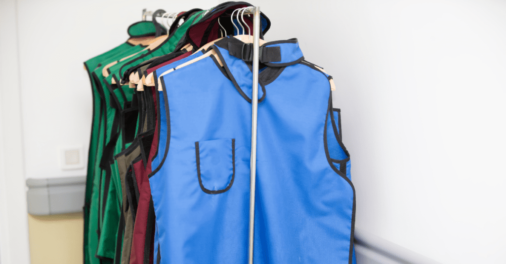 lead aprons and vests hung on a rack