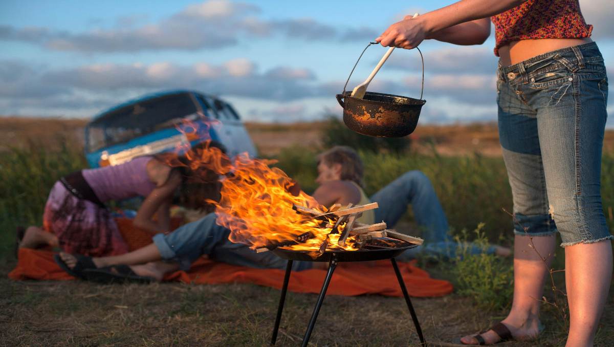 Preppers camping and cooking on fire.