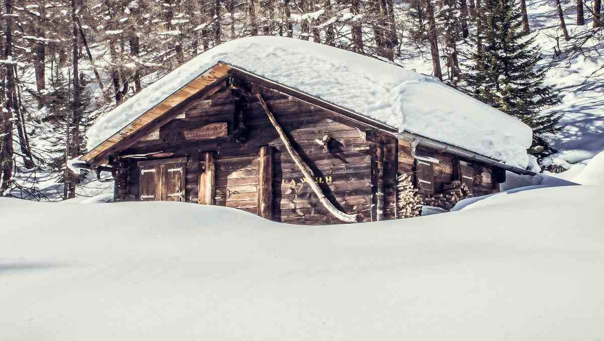 A cabin filled with snow.